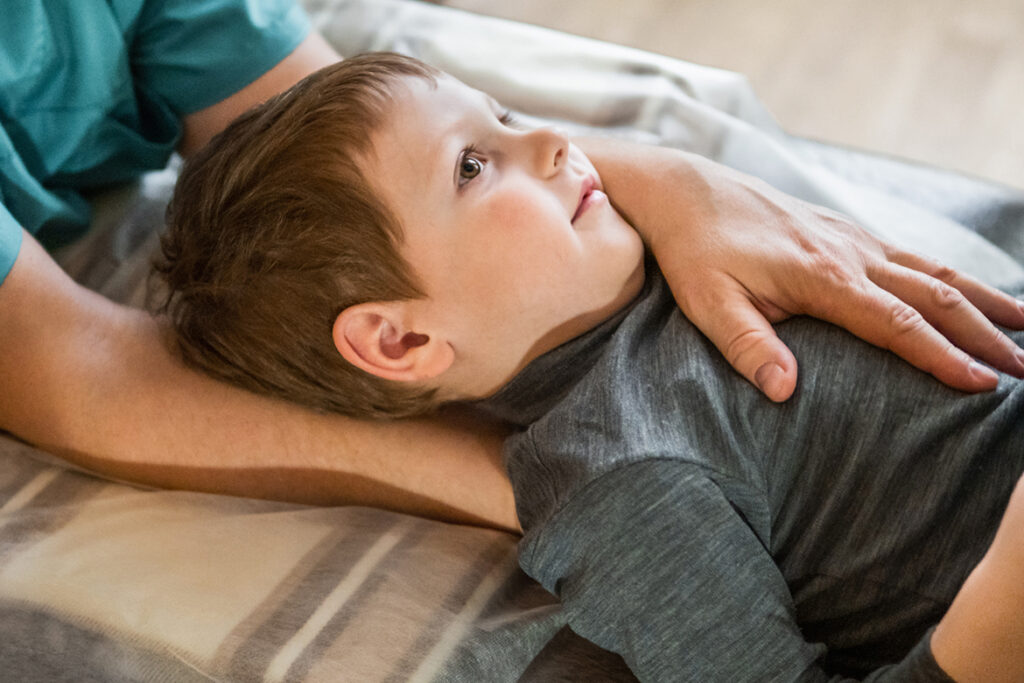 Boy Receive Cranial Osteopathy Osteopath near me treat a boy for Cranial Osteopathy